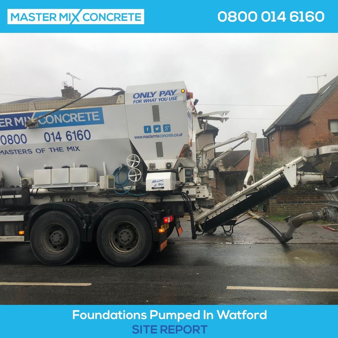 a Master Mix concrete mixer on a rainy construction site in Watford