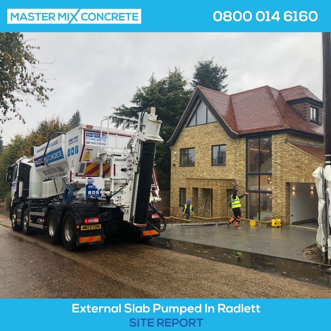a Master Mix concrete mixer on a rainy construction site in Watford
